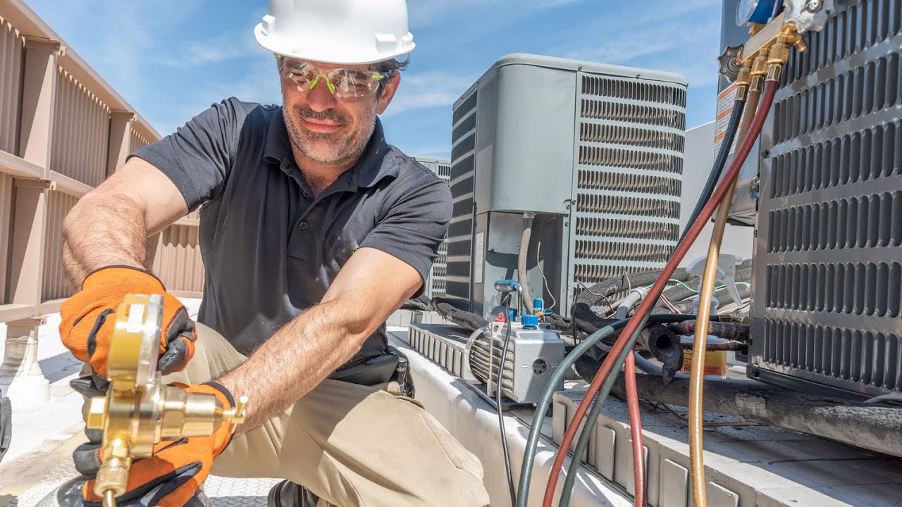 Technician performing HVAC repair in West Hollywood home